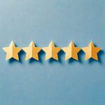 A-paper-craft-art-style-image-featuring-a-single-horizontal-row-of-five-evenly-spaced-cut-out-paper-stars.-The-stars-are-made-of-gold-colored-paper-s-1.jpeg